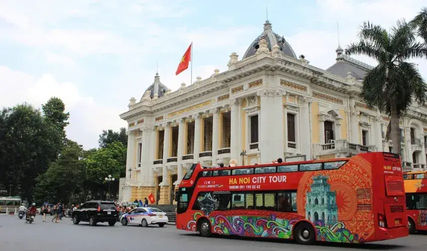 Tourist buses take visitors to explore Hanoi's famous landmarks