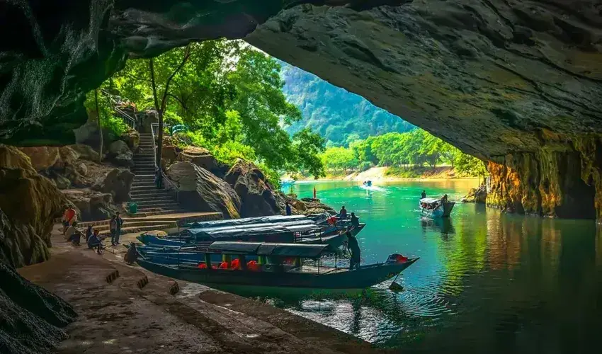 Tourists travel by boat directly inside the cave