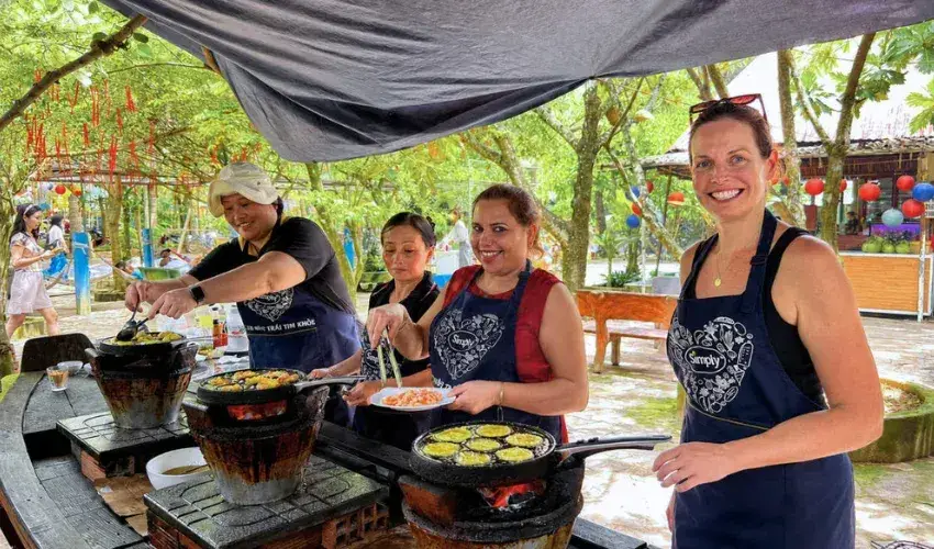 Tourists experience making traditional Vietnamese pancakes (banh khot) in the Mekong Delta