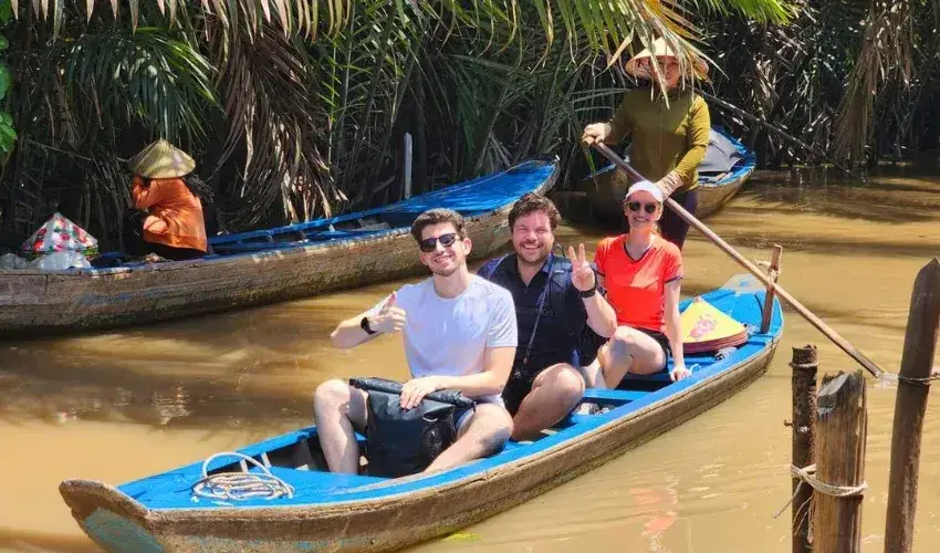 Paddle a boat and admire the canals surrounded by lush green coconut trees