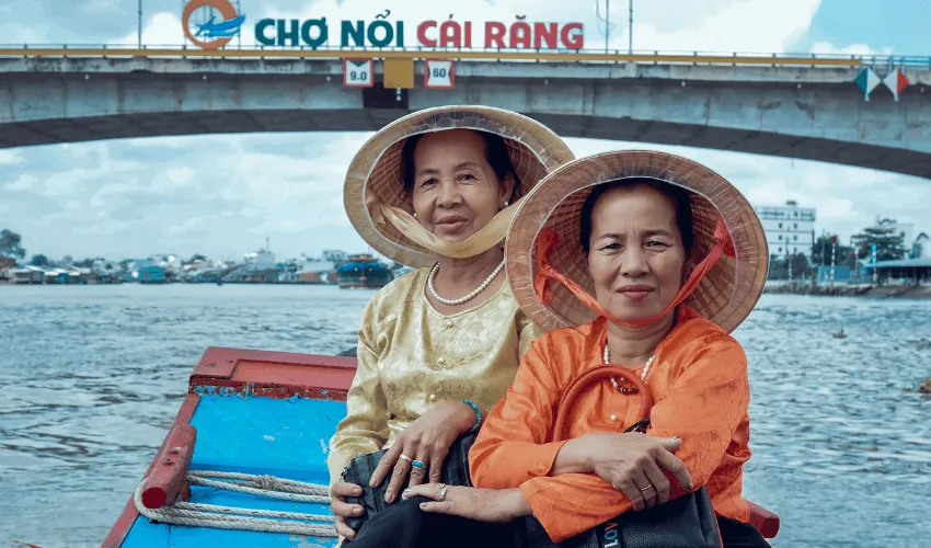 Travelers exploring the Mekong Delta by boat on a Vietnam highlights tour