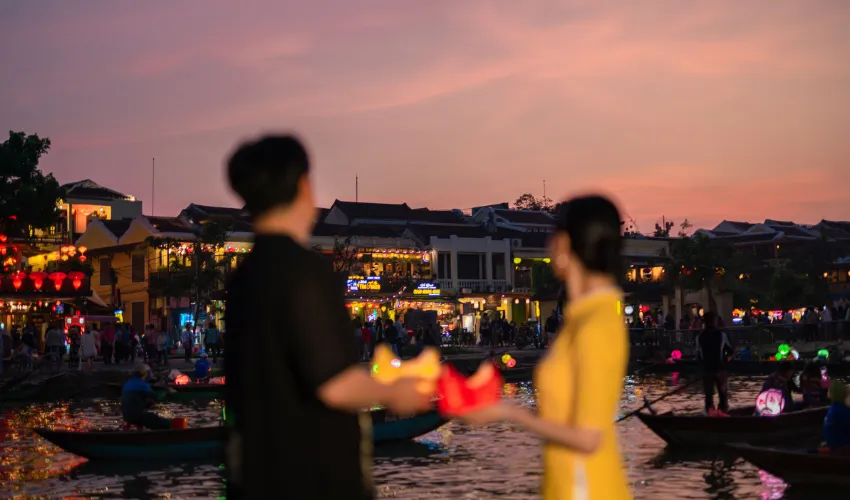 Couple enjoying a romantic evening by the river in Hoi An Vietnam