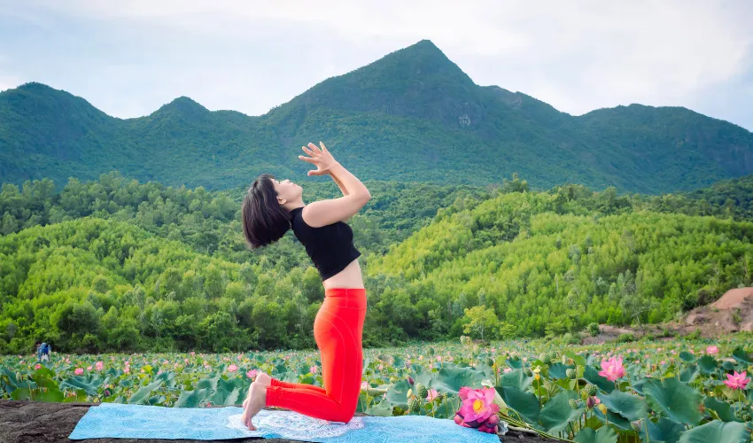 Yoga among lotus fields on a wellness and spa tour in Hoi An Vietnam